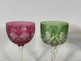 two wine glasses sitting next to each other on a table