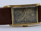 a watch that is sitting on a brown leather strap