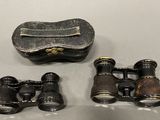 a pair of binoculars and a pair of scissors on a table