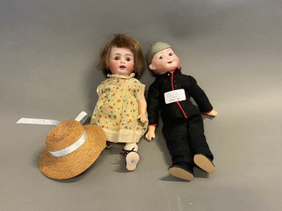 two dolls sitting next to each other on a table