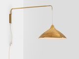 a large image of the person wall lamp in brass with a white background