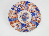 a plate with a blue, orange and white design on it