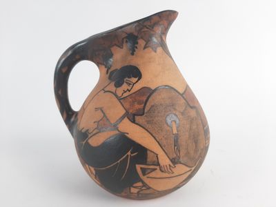 a vase with a painting of a woman on it