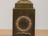 pair of antique bronze vases on pedestal on wooden table