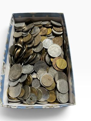 a box full of coins sitting on a white surface