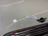 a close up of a white car with a sticker on it