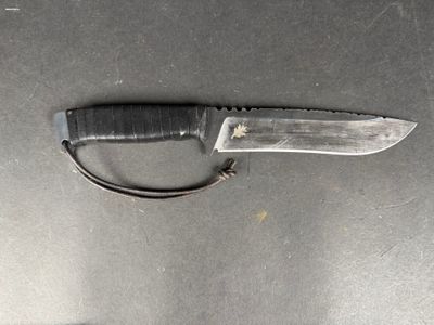 a knife that is laying on a table