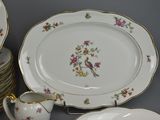 a lot of plates and cups that are on a table