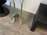 a glass table with a pair of tongs on top of it