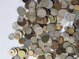 a pile of coins sitting on a white surface