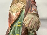 a statue of a man holding a fish in his hand