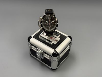 a watch sitting on top of a suitcase on a table
