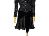 an image of a mannequin wearing a black dress on a wooden stand