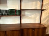 a book shelf with books on it in a room