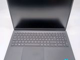 an open laptop computer sitting on top of a white table