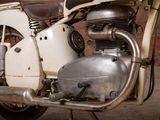 a close up of a motorcycle parked in front of a brick wall