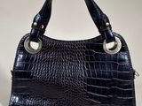 a black crocodile skin handbag on a white background