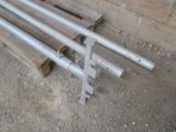 a bunch of pipes sitting on the ground next to a brick wall
