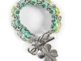 un gros plan sur un bracelet orné d'un pendentif en forme de trèfle