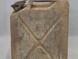 an old metal canister with a metal handle on a white surface