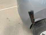 a close up of a car ' s front bumper with a sticker on it
