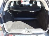 the back of a car with the trunk open and the seats down
