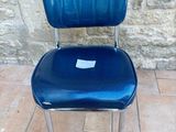 a blue chair that is sitting on a tile floor