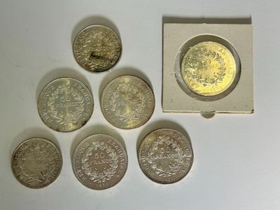 six different british coins sitting in a small box on a table