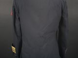 the back of a military jacket with a gold stripe on the chest