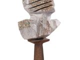 a sculpture of a rock on a stand on a white background