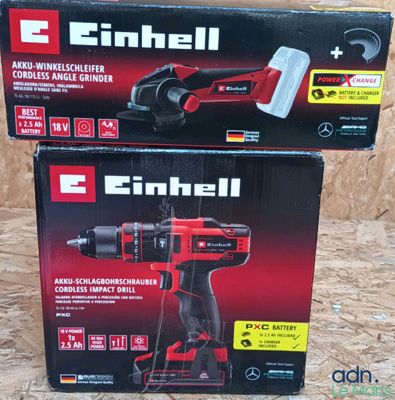 two boxes of electric tools sitting on top of a wooden surface