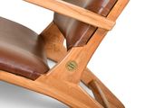 the chair is made of wood and has a brown leather seat