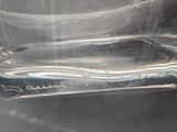 a glass with a toothbrush in it sitting on a table