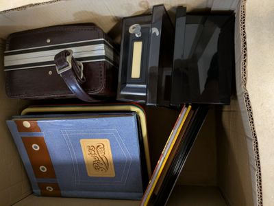 a cardboard box filled with various types of luggage
