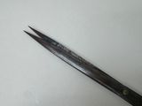 a pair of scissors sitting on a white surface