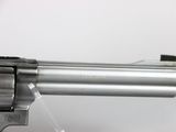 a close up of a revolver on a table with a white background