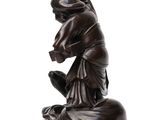 an image of a statue of a person kneeling on the ground