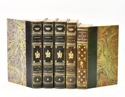 three books are stacked on top of each other on a white surface