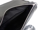 a black purse that is open on a white surface