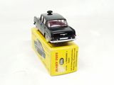 a black toy car sitting on top of a yellow box
