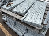 a pile of metal items on the ground in the parking lot
