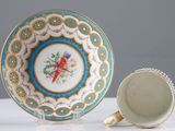 a cup and saucer sitting on a table