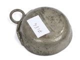a metal bell that has a tag on it