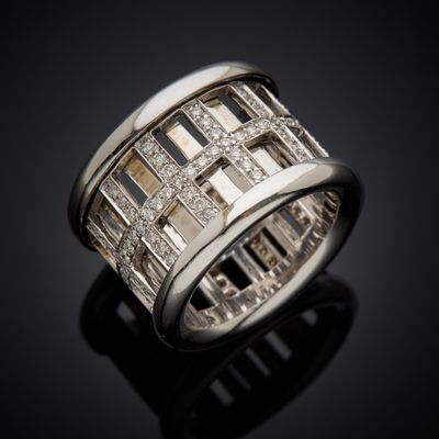 a close up of a diamond ring on a black surface