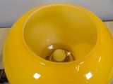 a yellow bowl that is sitting on a table
