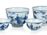 four blue and white bowls and cups with designs on them