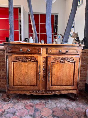 a wooden cabinet with a red door in a room