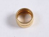a close up of a gold ring on a white surface