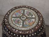 a small decorative table with a flower design on it