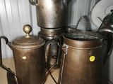 several pots and pans are sitting on a shelf in a kitchen